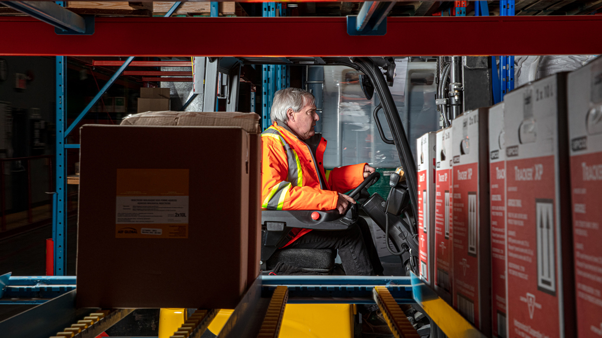 A worker drives a forklift in a Sollio Agriculture warehouse during the pandemic.